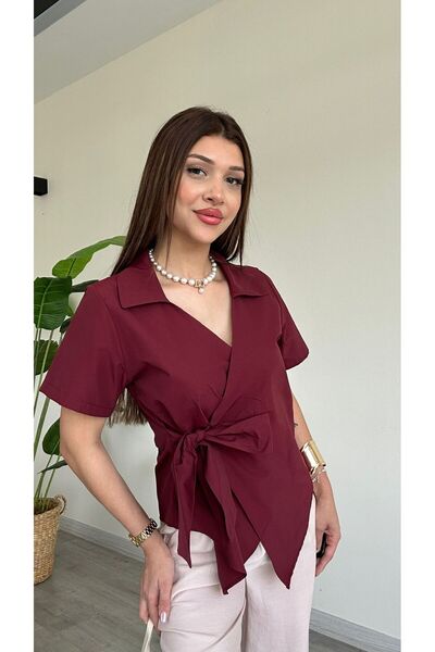 Şamdan A blouse with a waist tie, short sleeves, and a V-neck.