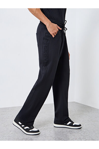Styli Men Black Oversized Side Embossed Joggers
