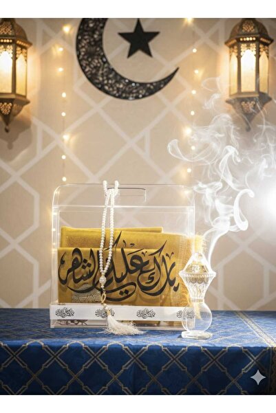 GIFT A transparent acrylic Ramadan gift box containing a Quran, prayer rug, i...