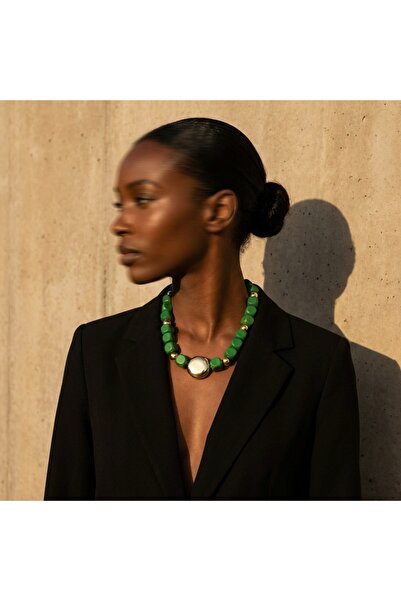 COCOSH TAKI Dark green wooden beaded necklace with gold accents.