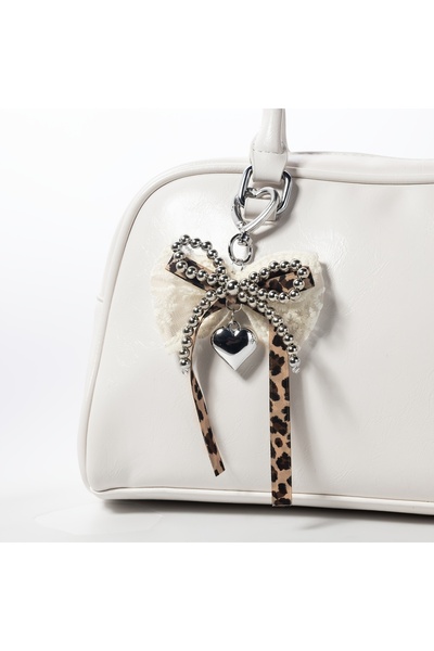 Viranes Leopard print bow bag charm with pearl and lace detail, headphone cha...