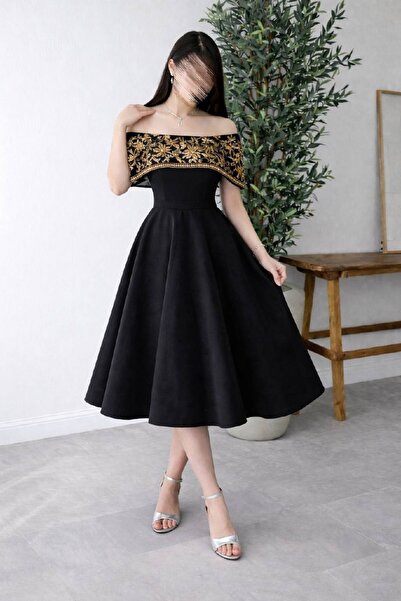 Calissa Store A sleek black off-the-shoulder dress with gold embroidery