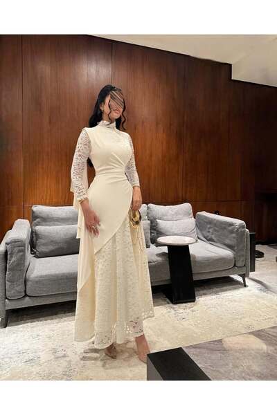 REVE A modest white dress with a high neckline, combining lace with elegant s...