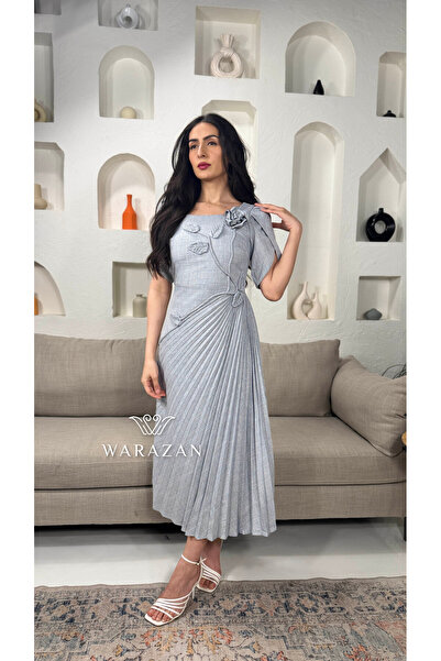 Warazan A soft dress with a rose cut off the shoulder and pleats