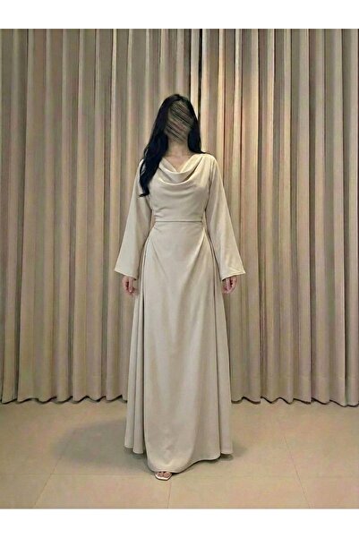 DUBAİ A cream-colored dress with an elegant design that reflects softness and...