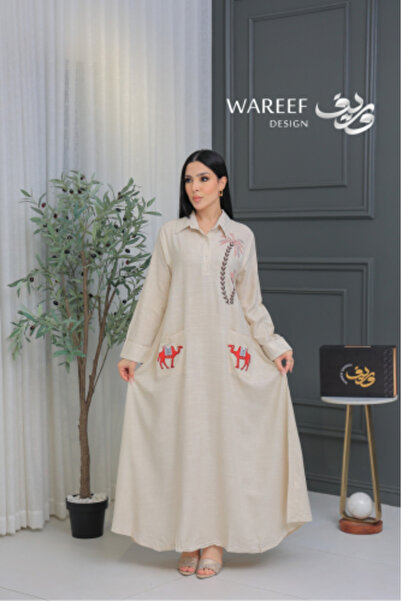 WAREEF FASHION A jalabiya in a calm sand color with camel embroidery and soft...