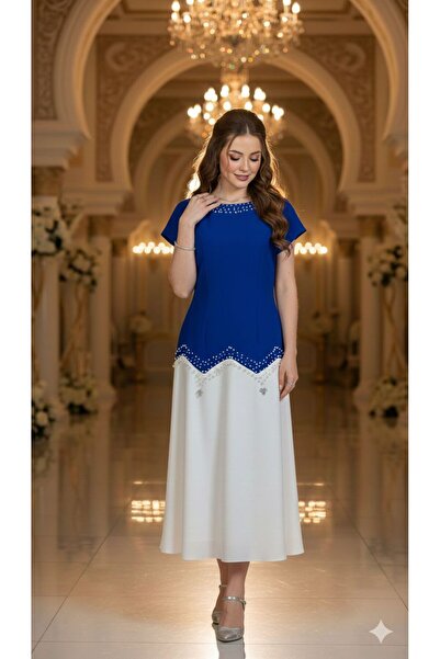 NARCISSUS FASHION An elegant evening dress with an asymmetrical design and lu...