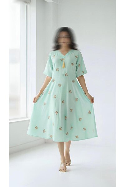 ISHRAQAT AL-AMAL A short dress with short sleeves, a half-circle design, and ...