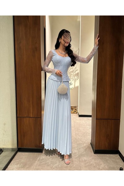 Meryl Light blue evening dress with lace, sheer sleeves, and a pleated skirt.