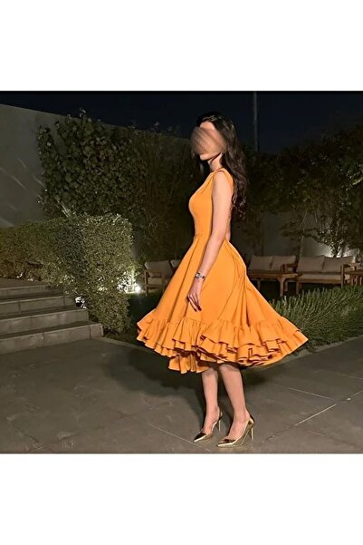 RANA DRESSES A short yellow dress with a modern design that catches the eye