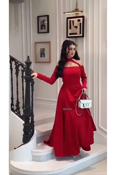 Cutie A royal red evening dress with an off-the-shoulder neckline and a disti...