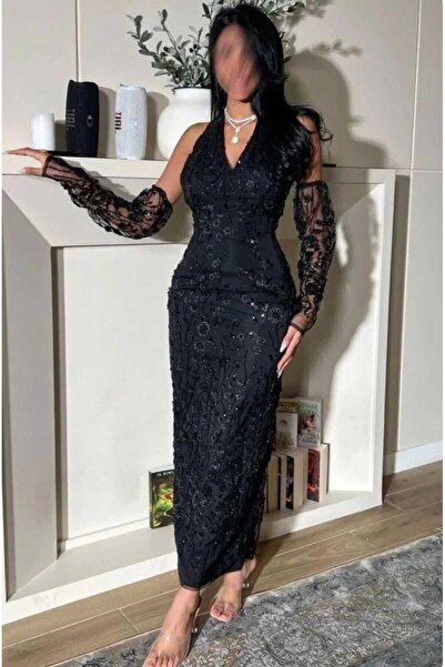 Masha A luxurious black evening dress with sequin and bead embellishments.