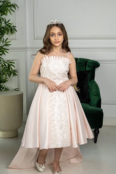 Generic A girl's dress with delicate embroidery and an elegant train, perfect...