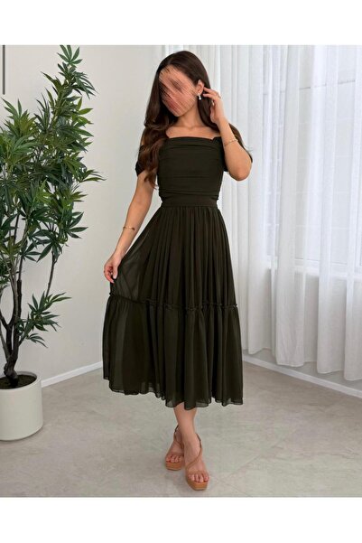 ProWorks & RTC A soft, olive-green dress with a simple and elegant cut.