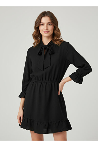 NEW JOURNAL Fusta neagră cu talie elastică și rochie mini cu volane pe mâneci...