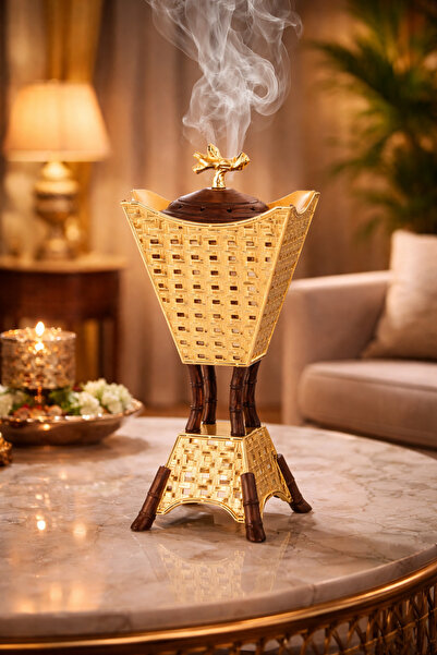 Dania A luxurious incense burner with a traditional gold design and wooden de...
