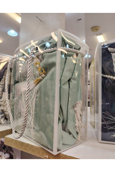 Gerenic Box containing a prayer mat, sheet, and rosary