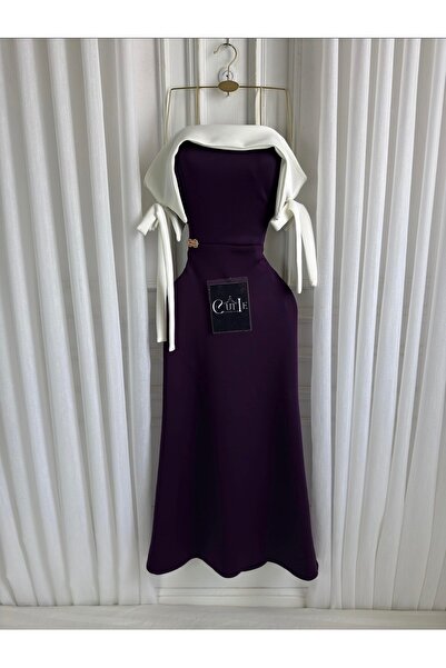 Cutie A modern evening dress with an off-the-shoulder design and charming bow...