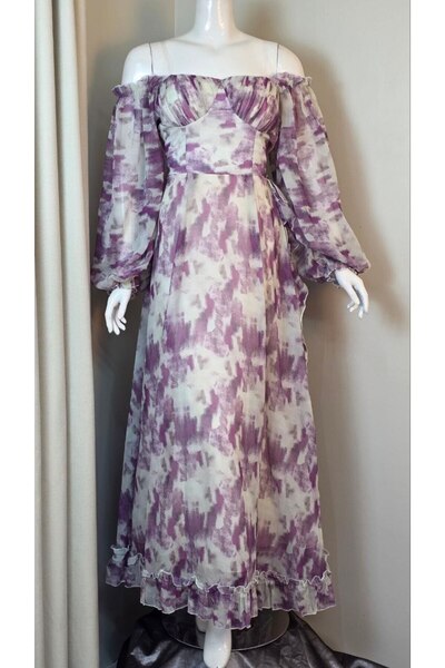 LEVAR A maxi dress with ethereal patterns that blend white and purple.