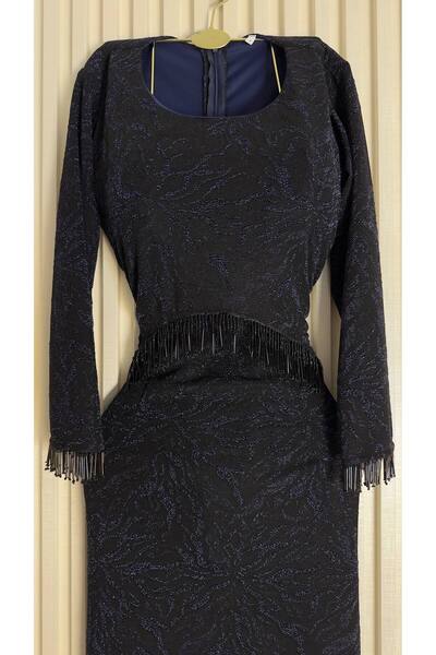 SSS A stylish long black dress featuring several striking design details.