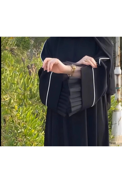 Abay-ti A black abaya with white trim and luxurious tulle on the sleeves… a d...