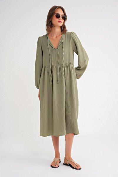 Hiccup Mixray midi dress with V-neck and knot closure, loose fit