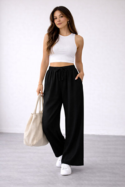 Tutals بنطلون بالازو نسائي أسود اللون من الموسلين بخصر مطاطي ورباط وتصميم فضف...