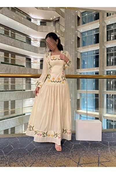 Cutie A long Eid dress with elegant floral embroidery and a sophisticated des...