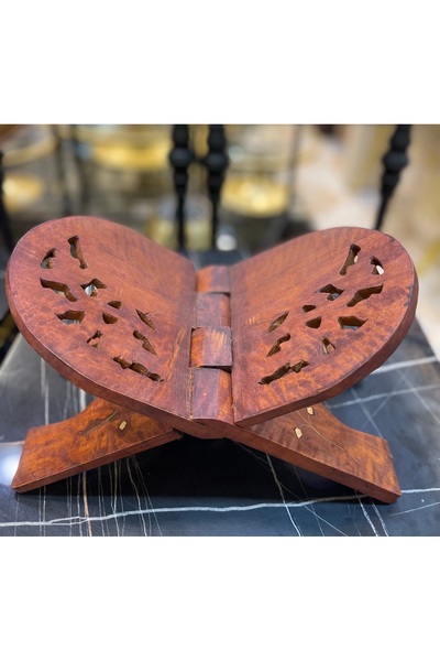 HomeNew A Quran stand made of natural wood inlaid with copper.