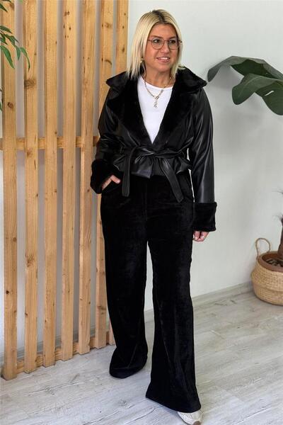 By Esra Celkan سترة من الجلد الصناعي سوداء مع أكمام وياقة من الفرو وحزام قصير