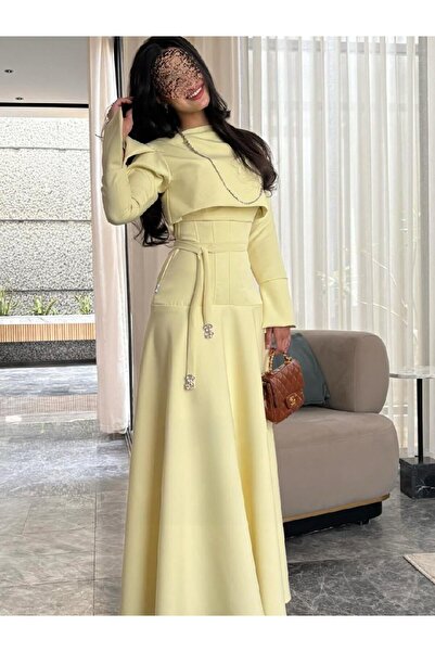 REVE A modern lemon-colored dress with a "corset" design that accentuates the...