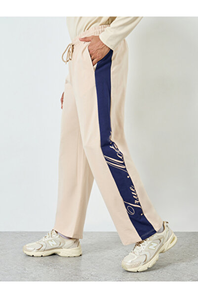 Styli Men Beige Oversized Contrast Panel Printed Joggers