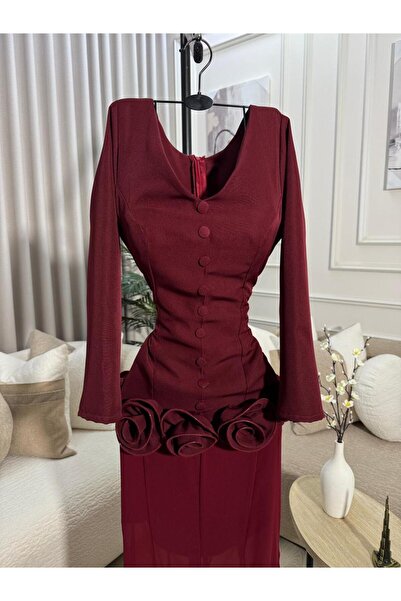 FASHION A long burgundy dress adorned with prominent roses at the waist, feat...