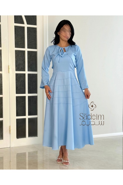 SADIEM A wide, light blue evening dress with luxurious embroidery
