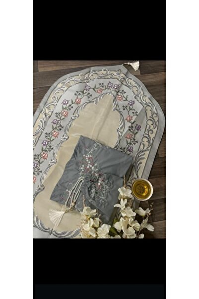 RUG A medium gray embroidered prayer set, featuring colorful floral patterns ...