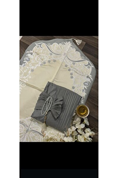 RUG A dark gray pleated prayer set, featuring a practical material and a whit...