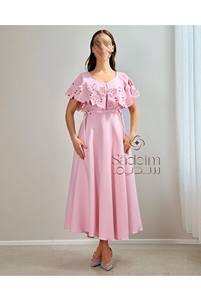 Sadeim A flowing pink evening dress with a cape adorned with rose details.