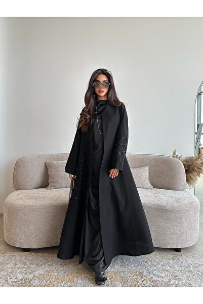 outline A black Eid abaya in Limar fabric adorned with sequins - a luxurious ...