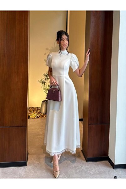 Special-DIARA A soft white midi dress with an elegant design that combines cl...