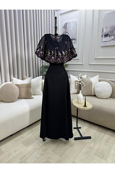 FASHION A soft black dress with a flowing cut, adorned with a cape top embroi...