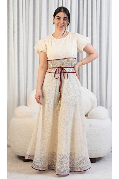 DVNA Asala's dress is embroidered with lace and features a wide velvet Belt .