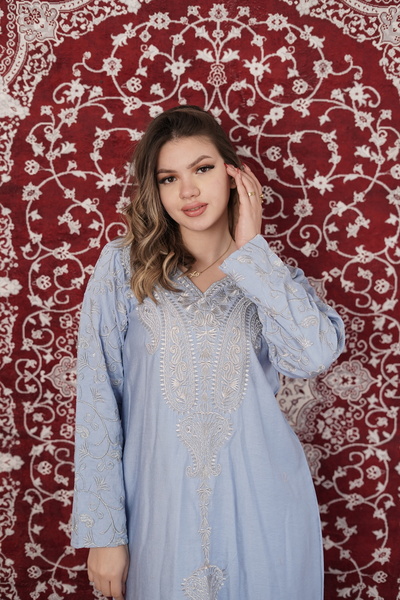AFandina An elegant jalabiya with embroidered details that reflects a luxurio...