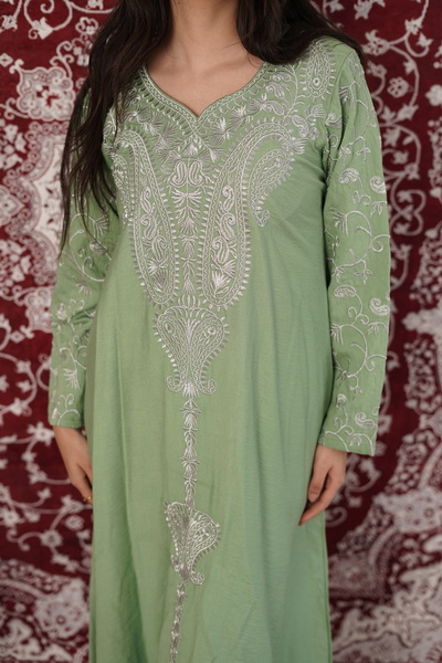 AFandina An elegant jalabiya with embroidered details that reflects a luxurio...