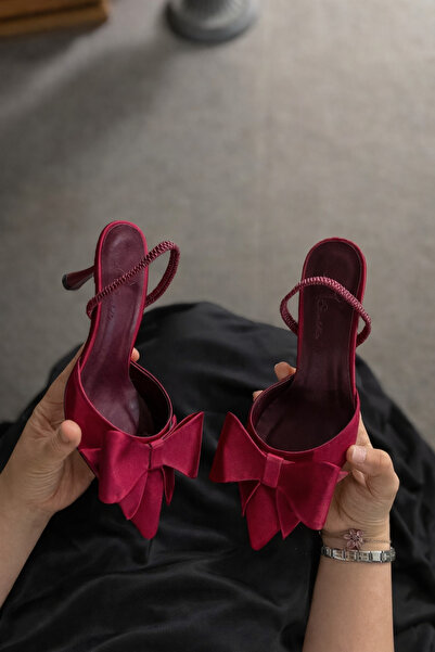 STOCON حذاء نسائي بكعب عالٍ من Mayje باللون العنابي مع تفاصيل فيونكة من السات...