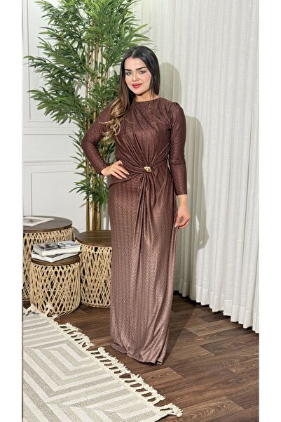 TREASUREISLAND A long, shimmering brown evening dress with a touch of sophist...