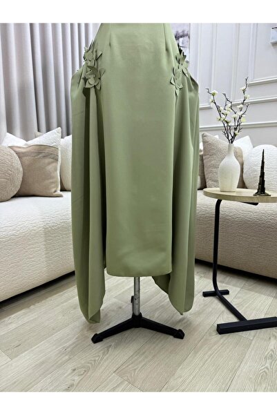 FASHION A midi dress in a calm olive green color, decorated with prominent ro...