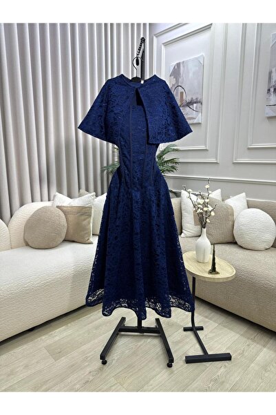 FASHION A luxurious navy blue lace midi dress with a cape top that highlights...