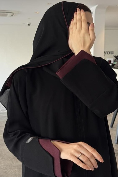 Karmen Trendy black crepe abaya with a hidden snap closure and an accompanyin...