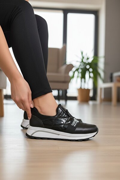 enoch حذاء رياضي نسائي بتفاصيل لامعة وشريط مزين بالشعار