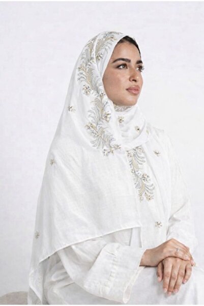 Veil Designer A veil with gold and black embroidery covering the entire veil,...